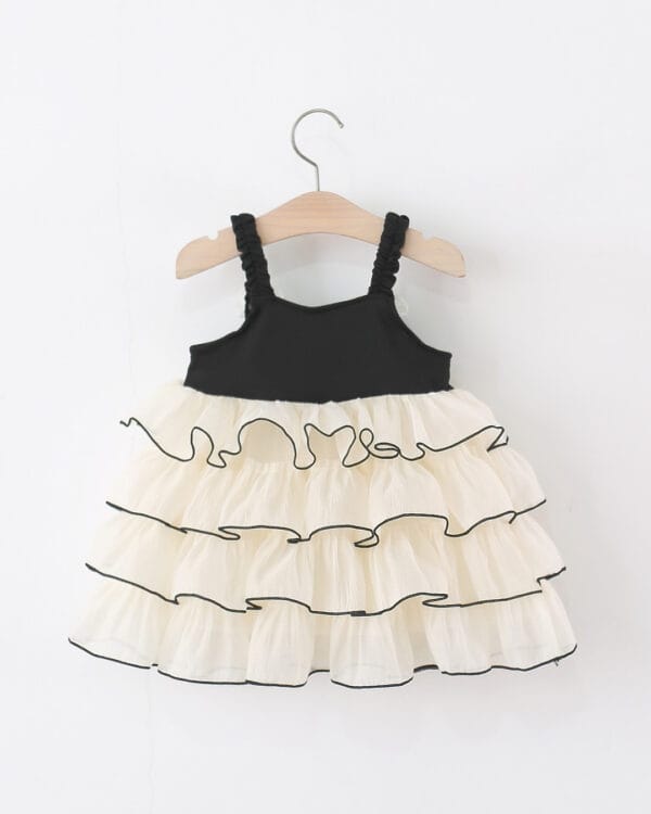 Βρεφικό φόρεμα μαύρο-κρεμ με βολάν - Image 2
